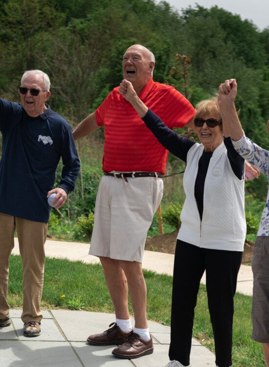 group of seniors celebrate together outside