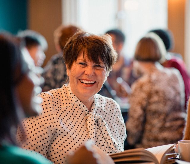 seniors laugh and converse during book club