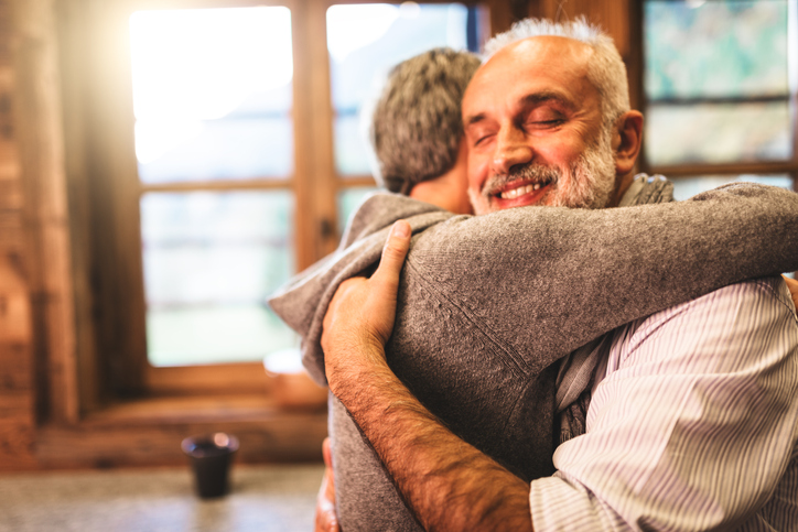 two seniors embrace in a hug