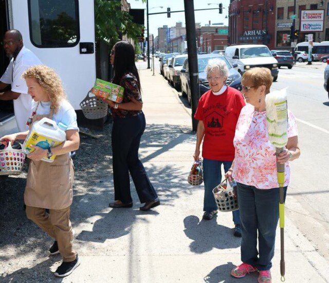 group of seniors help deliver donated supplies to charity