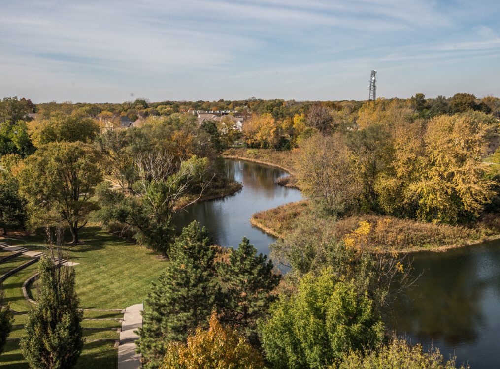 Aerial view of large body of water and walking paths at Oak Trace Senior Living Community